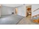 Open-concept living room featuring neutral paint, tiled flooring and a staircase at 6709 Mornay Cir, Tampa, FL 33615