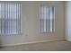 Spacious bedroom with neutral carpeting and two windows with blinds at 2346 Lake Woodberry Cir, Brandon, FL 33510