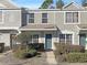 Two-story townhome with gray siding, landscaping, and a walkway at 2346 Lake Woodberry Cir, Brandon, FL 33510