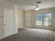 Bright living room featuring neutral carpeting and a view of the front door at 2346 Lake Woodberry Cir, Brandon, FL 33510