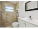 Modern bathroom with tiled shower, white vanity, and updated fixtures at 6007 Ambassador Dr, Tampa, FL 33615