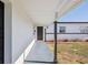 Welcoming entryway with a modern black door, freshly painted walls, and manicured landscaping at 6007 Ambassador Dr, Tampa, FL 33615