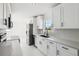 Bright, newly renovated kitchen with stainless steel appliances, quartz countertops, and ample cabinet space at 6007 Ambassador Dr, Tampa, FL 33615