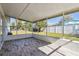 Enclosed patio with wood-look floors, offering a relaxing outdoor living space with backyard views at 6007 Ambassador Dr, Tampa, FL 33615