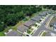A birds eye view showcasing new homes with green lawns and verdant tree lined property lines at 7729 Rosewood Garden Loop, Tampa, FL 33637