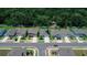 An aerial perspective shows the street, homes, lawns, and the border between the neighborhood and a forest at 7729 Rosewood Garden Loop, Tampa, FL 33637