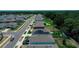 Community aerial view featuring cozy homes, green lawns, and a lush forest backdrop at 7729 Rosewood Garden Loop, Tampa, FL 33637
