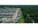 Overhead view of houses showcasing an organized neighborhood plan surrounded by lush trees at 7729 Rosewood Garden Loop, Tampa, FL 33637