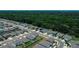 Sprawling community showcasing well-manicured streets, modern homes, green spaces, and a tree lined boundary at 7729 Rosewood Garden Loop, Tampa, FL 33637