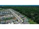 Expansive community aerial view with numerous homes, trees, and a vast green area at 7729 Rosewood Garden Loop, Tampa, FL 33637
