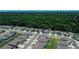 Neighborhood aerial view with a backdrop of dense trees and a variety of homes at 7729 Rosewood Garden Loop, Tampa, FL 33637