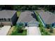 Charming single-story home with gray roof, solar panels, two-car garage, and a well-maintained front yard at 7729 Rosewood Garden Loop, Tampa, FL 33637