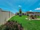 Spacious backyard with green grass and patio seating at 7729 Rosewood Garden Loop, Tampa, FL 33637