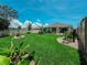 Well-manicured backyard featuring a lush lawn, garden, and fence at 7729 Rosewood Garden Loop, Tampa, FL 33637