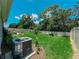 Large backyard featuring lush green lawn, garden areas, and a white fence at 7729 Rosewood Garden Loop, Tampa, FL 33637