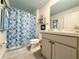 The full bathroom features a shower tub combo, blue accents, and ample storage at 7729 Rosewood Garden Loop, Tampa, FL 33637