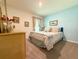 Comfortable bedroom with soft carpet, decorative pillows, and elegant dresser at 7729 Rosewood Garden Loop, Tampa, FL 33637