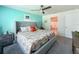 Comfortable bedroom with a large bed, colorful accent wall, and an attached bathroom at 7729 Rosewood Garden Loop, Tampa, FL 33637
