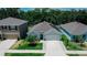 Charming home exterior with manicured lawn, inviting entrance, and attached two-car garage at 7729 Rosewood Garden Loop, Tampa, FL 33637