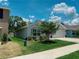 Charming single Gathering home with a well manicured lawn and front flower beds in the neighborhood at 7729 Rosewood Garden Loop, Tampa, FL 33637