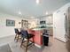 Bright kitchen featuring an island with bar seating, stainless steel appliances, and ample cabinet space at 7729 Rosewood Garden Loop, Tampa, FL 33637