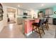 Modern kitchen with island, breakfast bar, gray cabinets, and stainless steel appliances at 7729 Rosewood Garden Loop, Tampa, FL 33637