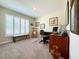 A dedicated office space features a large window, neutral carpet, and comfortable work arrangements at 7729 Rosewood Garden Loop, Tampa, FL 33637