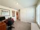 A bright home office space features a large window and soft carpet for added comfort at 7729 Rosewood Garden Loop, Tampa, FL 33637