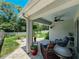Inviting covered patio features comfortable seating and barbecue, perfect for outdoor entertaining at 7729 Rosewood Garden Loop, Tampa, FL 33637