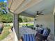 Relaxing covered patio with seating and a grill at 7729 Rosewood Garden Loop, Tampa, FL 33637