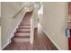 Staircase with wood-look flooring and a neutral color scheme at 1867 Briland St, Tarpon Springs, FL 34689