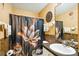 Clean bathroom with floral shower curtain at 13145 Arkendale St, Spring Hill, FL 34609