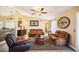 Spacious living room featuring leather furniture and a ceiling fan at 13145 Arkendale St, Spring Hill, FL 34609