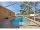 Inviting screened pool with water feature at 13145 Arkendale St, Spring Hill, FL 34609