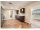 Kitchen boasts dark cabinetry, granite counters and tile floors at 5023 Thames Dr, New Port Richey, FL 34652
