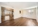 Open living area with wood-look flooring and kitchen view at 5023 Thames Dr, New Port Richey, FL 34652