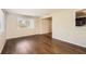 Living area with wood-look floors and access to kitchen at 5023 Thames Dr, New Port Richey, FL 34652