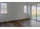 Bright bedroom with wood-look tile floors and sliding glass doors at 10625 Ayear Rd, Port Charlotte, FL 33981