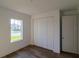 Bright bedroom with white walls, wood-look floors, and a large closet at 10625 Ayear Rd, Port Charlotte, FL 33981