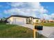 Front view of a single-story house with a driveway and mailbox at 10625 Ayear Rd, Port Charlotte, FL 33981