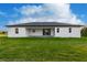 Rear view of a single-story house with covered patio at 10625 Ayear Rd, Port Charlotte, FL 33981