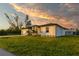 Side view of a single story house with sunset in the background at 10625 Ayear Rd, Port Charlotte, FL 33981