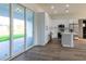 Modern kitchen with island and stainless steel appliances and access to patio at 10625 Ayear Rd, Port Charlotte, FL 33981