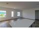 Bright and airy living area with tile floors and access to the kitchen at 10625 Ayear Rd, Port Charlotte, FL 33981