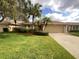 Well-maintained house with a landscaped lawn and attached garage at 2253 Heron Cir, Clearwater, FL 33762