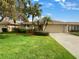 Well-maintained house with a landscaped lawn and attached garage at 2253 Heron Cir, Clearwater, FL 33762