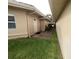Side yard with a pathway leading to a private gated entrance at 2253 Heron Cir, Clearwater, FL 33762