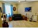 The comfortable living room displays musical instruments, a sofa and tiled floors at 10088 Cozy Grove Dr, Venice, FL 34293