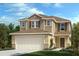 Two-story house with beige siding, brown roof, and a two-car garage at 37746 Williamette Way, Zephyrhills, FL 33540