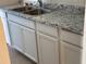 White kitchen cabinets under a granite countertop at 4944 Hazner St # 4944, New Port Richey, FL 34652